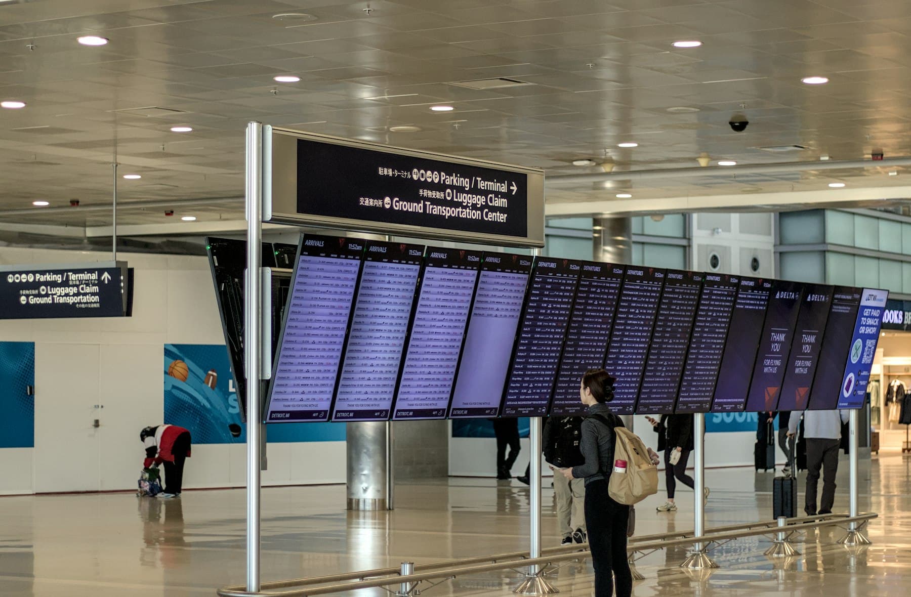 A traveler checking the departures board in an airport terminal